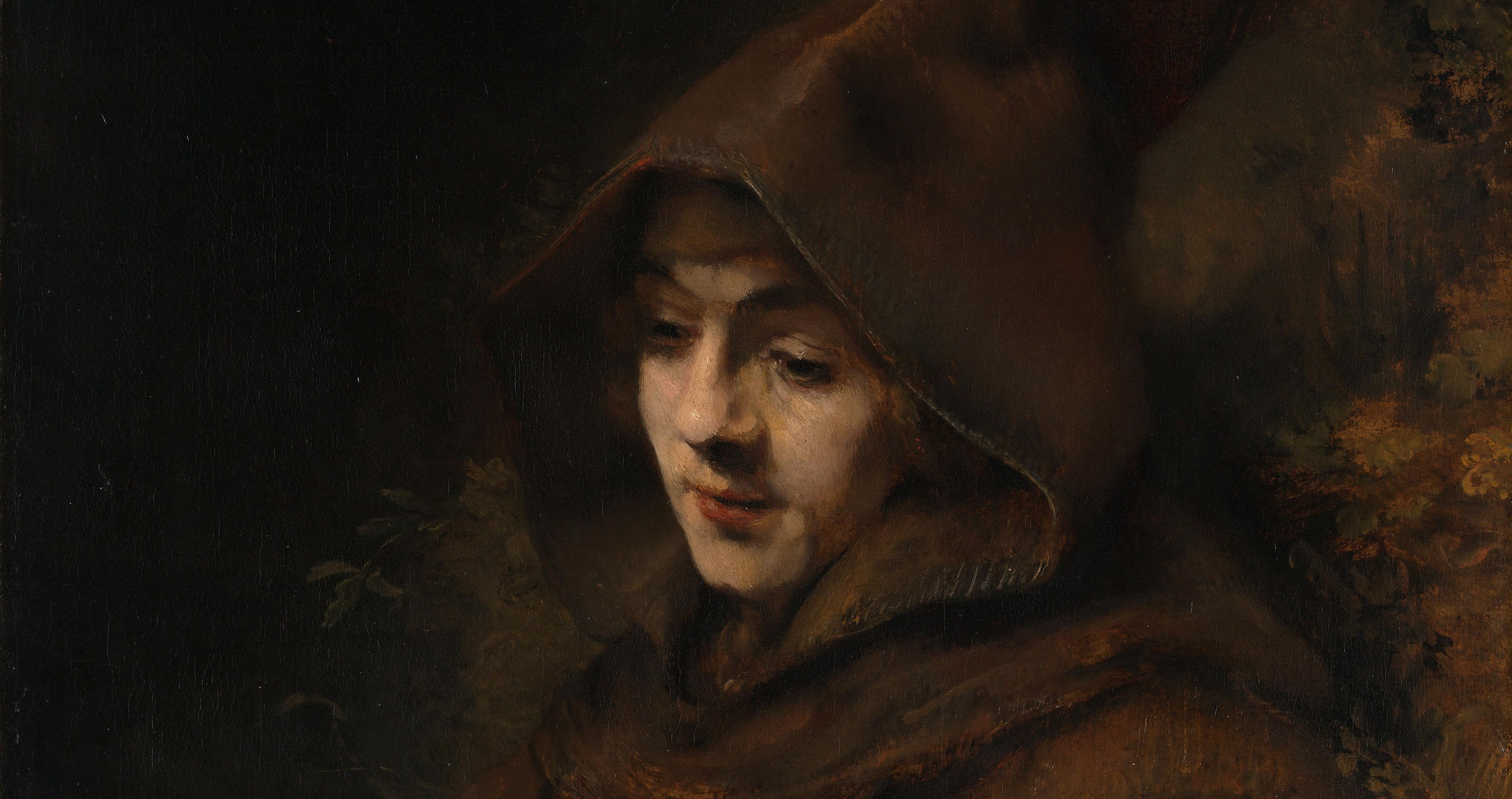 Portrait of young monk hooded looking down in humility